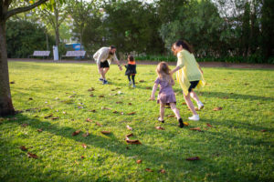 A family playing on the green grass field