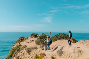 A group of friends hiking a coastal mountain