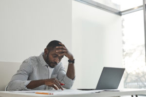 A man working with his hand on head