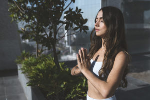 A woman meditating with her eyes closed