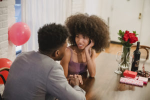 African american couple talking while having date at table