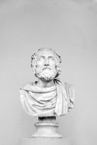 Bust of ancient philosopher on grey background