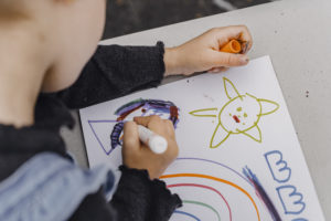 Crop child drawing on sheet of paper