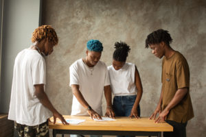 Group of focused black coworkers discussing project