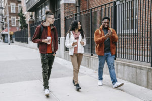 Group of multiracial students walking on street