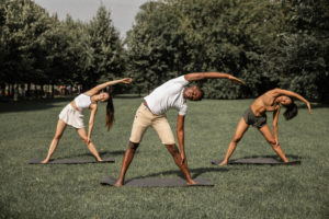 Multiracial people doing reverse triangle pose