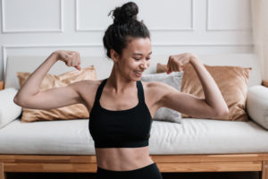 Woman in black sports bra showing her biceps