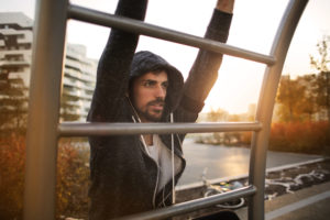 Active man exercising on sports ground