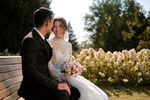 Bride and groom sitting on bench