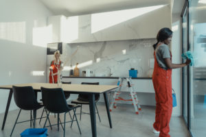 Women in working clothes cleaning the house